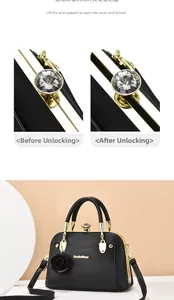 Detail of the elegant black handbag featuring a crystal lock and floral charm