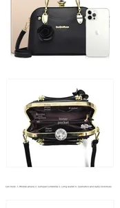Detailed view of black litchi leather handbag with rhinestone lock and multi-pocket interior