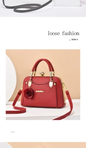 Detail of red vintage doctor-style handbag with floral charm and adjustable strap