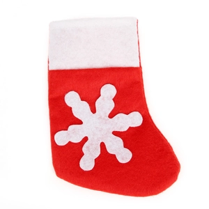 Christmas stocking cutlery holder with white snowflake pattern on red felt fabric