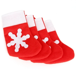 Set of four red felt Christmas stockings with white snowflake patterns for tableware