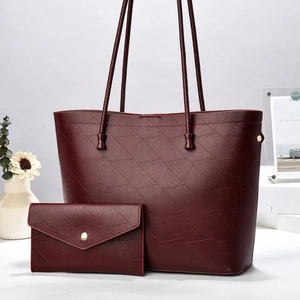 Burgundy textured leather tote bag set with matching envelope clutch and gold hardware