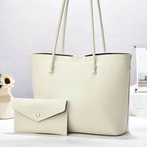 Creamy leaf-embossed tote bag set with matching envelope pouch and thin shoulder straps