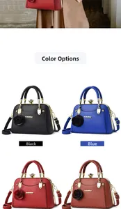 Detail of lychee pattern PU leather handbag with metallic handles and rose ornament