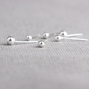 Macro shot of 925 sterling silver ball stud earrings in various sizes with mirror finish