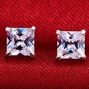 Macro shot of square-cut clear cubic zirconia stud earrings with silver 4-prong setting