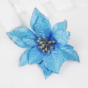 Close-up of blue artificial Christmas poinsettia with silver glitter edges on fabric petals