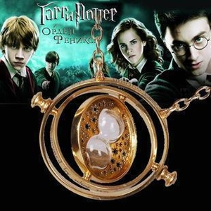 Detailed close-up of golden spinning time turner necklace with sand hourglass