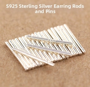 Macro shot of 925 sterling silver earring sticks in a bulk pack set on textured surface