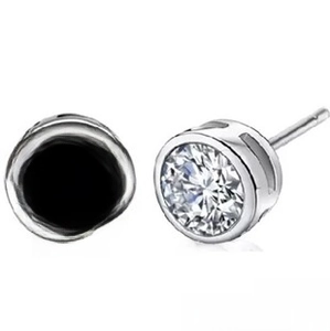 Detailed view of sterling silver studs with round black and clear cubic zirconia stones