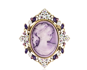 Macro detail of Victorian vintage cameo brooch with purple relief and gold crystal frame