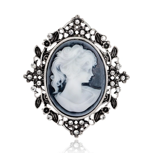 Vintage cameo brooch with female portrait profile in silver frame and sparkling rhinestones