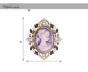 Close-up of vintage cameo brooch with purple resin relief and colorful crystal accents