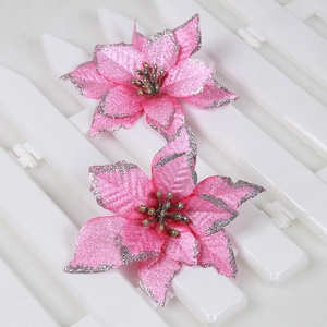 Close-up of pink artificial poinsettia flowers with silver glitter edges for decor