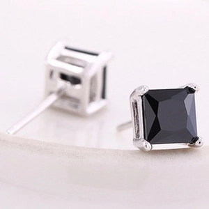 Detail view of 925 silver stud earrings with square-cut black zircon in prong setting
