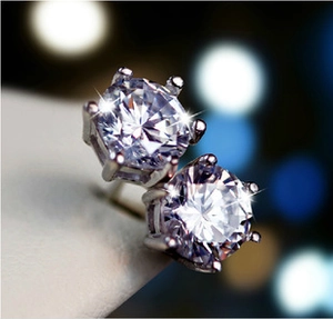 Macro shot of 925 sterling silver stud earrings with sparkling clear cubic zirconia