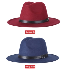 Detail view of wine red and navy blue wool fedora hats with leather belts and buckles