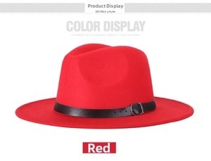 Detail of red wool fedora hat featuring a black leather band and silver metal buckle