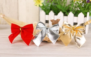 Detail of red flocked and glitter gold silver Christmas bows in a rustic basket