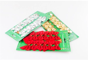 Close-up of 12-pack Christmas bows in red flocked and metallic gold and silver finishes