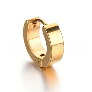 Macro detail of a wide gold stainless steel huggie earring with polished mirror finish