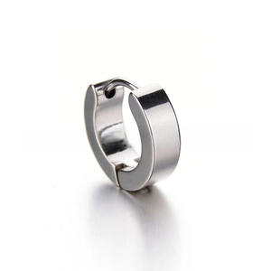 Macro detail of polished stainless steel silver hoop earring with a hinged clasp design