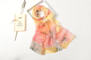 Detail of thin gradient silk scarf with lotus print and fine rolled edge craftsmanship