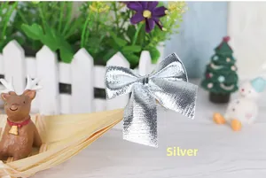 Close-up of a silver glitter textured Christmas bow knot on a festive background