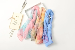 Close-up of lightweight gradient silk scarves with floral patterns and gift decor