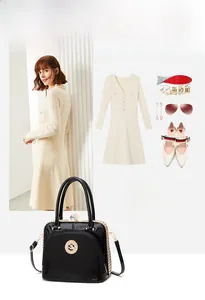 Fashionable black patent leather handbag with gold hardware styled with a beige dress