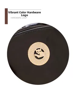 Detailed close-up of a golden leopard hardware plate with crystals on a black patent bag