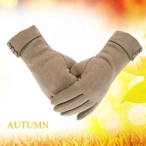 Detail of camel thermal knit gloves with decorative buttons for women in winter