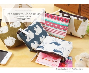 Flat lay of canvas coin purses with hedgehog, bear, and whale patterns on a wooden desk