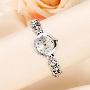 Silver quartz watch with pearl alloy bracelet and crystal accents on a display stand