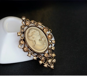 Macro detail of Victorian style brooch with portrait cameo and champagne crystals