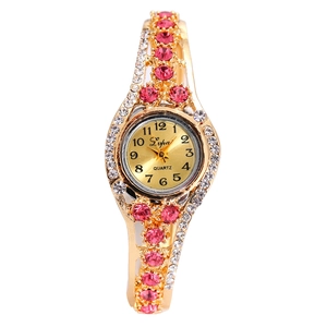 Close-up of luxury gold alloy watch with pink crystal rhinestones and hollow band