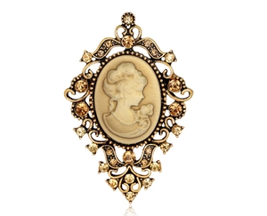 Macro shot of vintage lady cameo brooch with amber crystals and gold openwork details