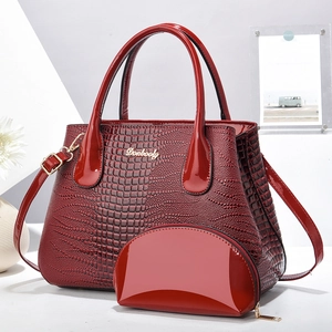 Deep red crocodile embossed leather tote bag and matching pouch set with gold logo
