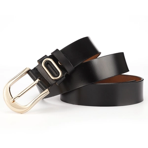 Detail of black genuine leather belt with a polished gold pin buckle and metal ring