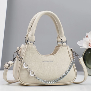 Minimalist beige lychee leather tote bag with silver chain and crescent moon charms