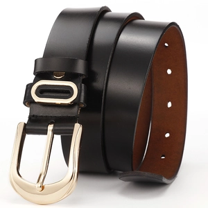 Macro view of a black genuine leather belt with a light gold needle buckle in spiral shape