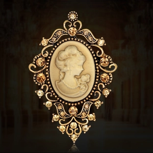 Vintage Victorian cameo brooch with golden filigree frame and amber crystal accents