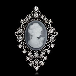Vintage cameo brooch with lady portrait relief and sparkling crystal accents on silver frame