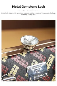 Close-up of golden hardware lock with faux gemstone on H-pattern leather handbag