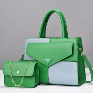 Detail view of green leather tote set with striped fabric and golden chain mini bag