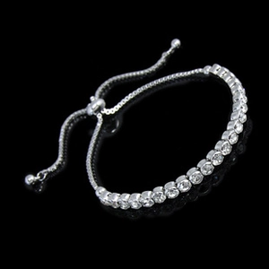 Close-up of silver zircon bracelet with an adjustable sliding clasp on black background