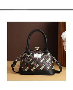 Front view of shell handbag with geometric pattern, crystal clasp and rabbit charm
