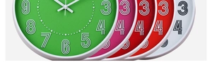 Detailed view of 12-inch plastic silent wall clocks in green, pink, red, and white colors