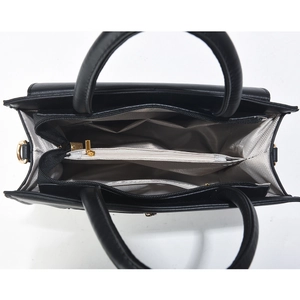 Interior view of black leather handbag featuring organized compartments and gold hardware