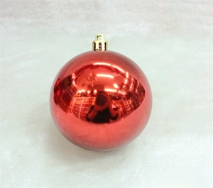 Close-up of a 3cm shiny red Christmas ball ornament with a golden hanging loop cap